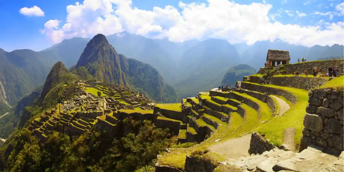 Machu Picchu panorama. Panoramana of Machu Picchu, Guard house, agriculture terraces, Wayna Picchu and surrounding mountains in the background. Concept of altitude sickness