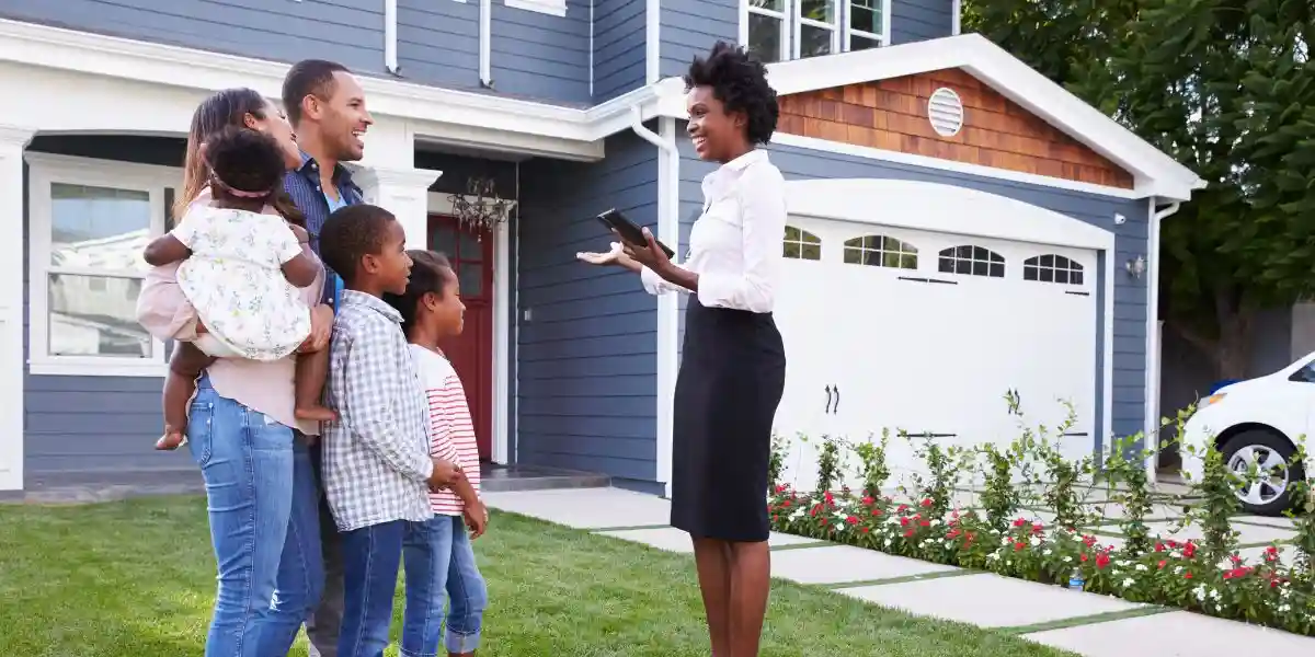 Real estate agent showing a family a house