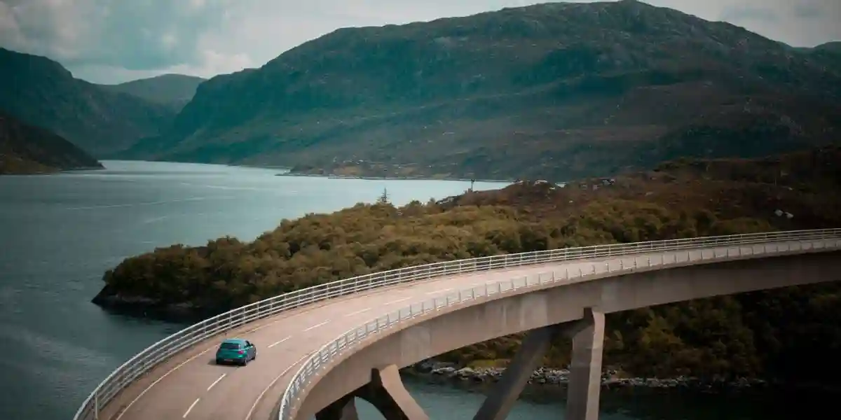 an ev car in scotland on a bridge over the water