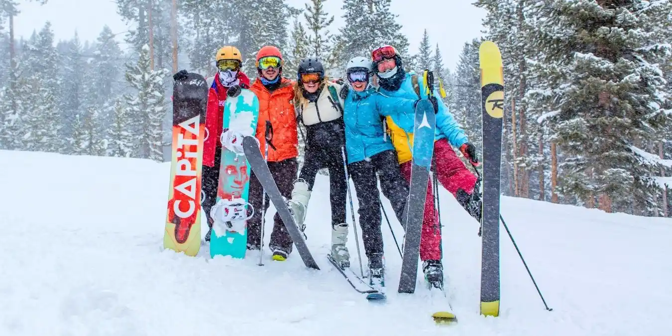 a group of people on a hillside with skis