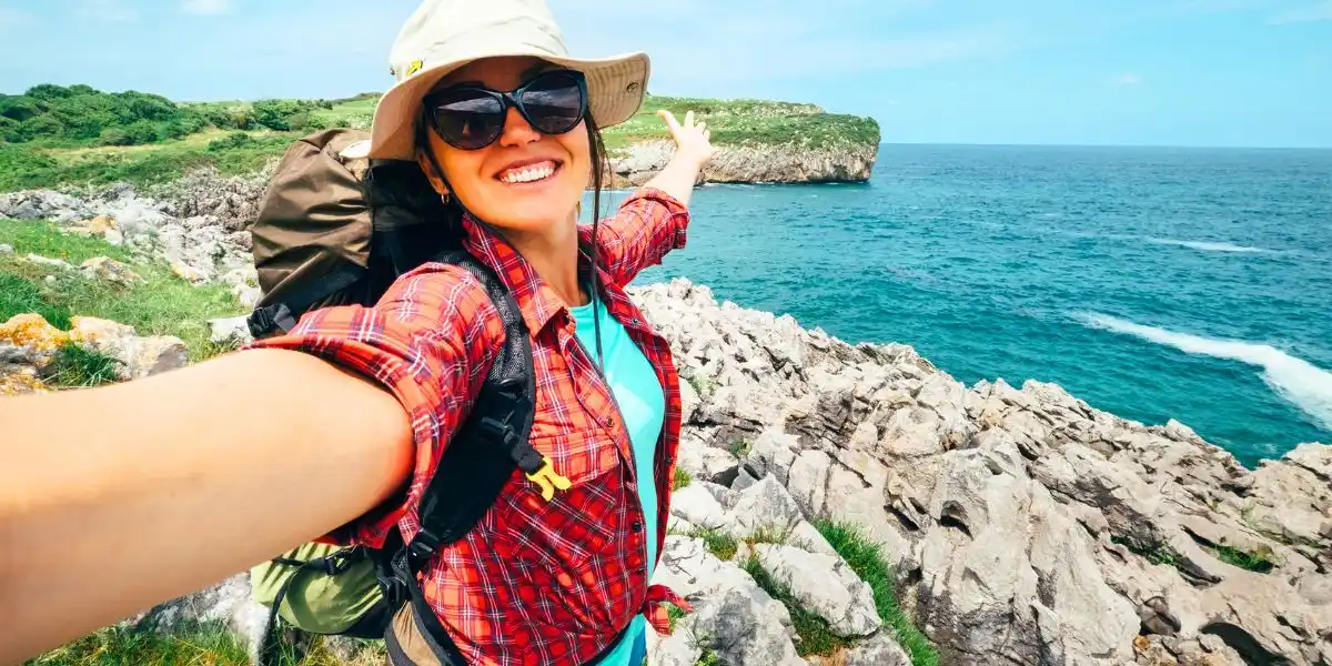 Woman on a clifftop taking a selfie